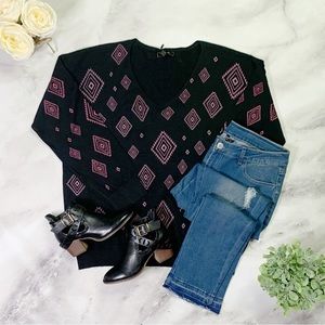 Curvy chic, boutique, black V-neck sweater with a pop of purple